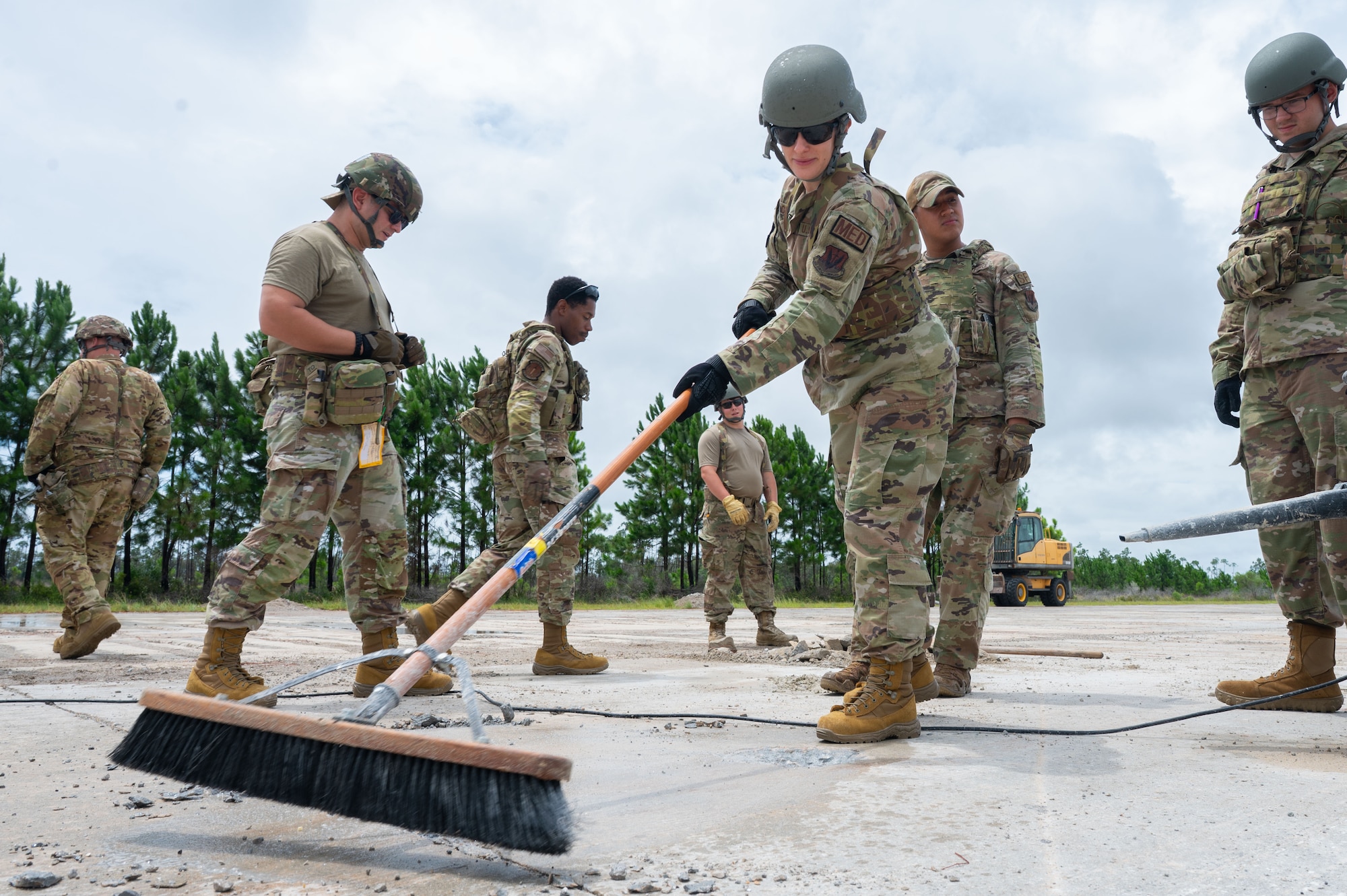 U.S. Air Force Airmen assigned to the 355th Combat Air Base Squadron clears spall from the flightline during Exercise Coyote Storm 26.1 at Tyndall Air Force Base, Florida, July 20, 2026. CS 26.1 strengthened unit cohesion by integrating Airmen from multiple units into cross-functional teams prepared to meet mission requirements. (U.S. Air Force photo by Airman 1st Class Jaden Kidd)