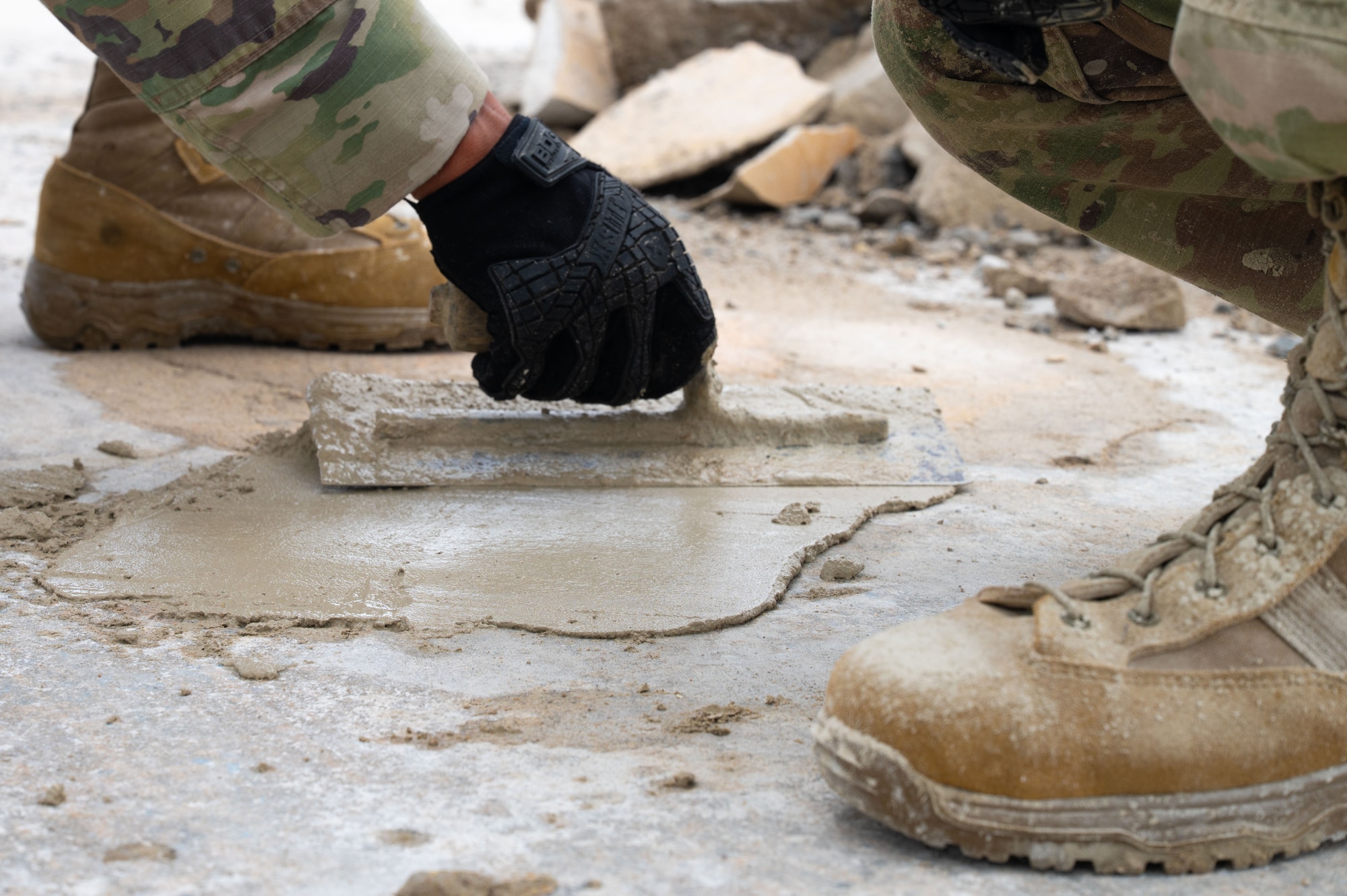 U.S. Air Force Airmen assigned to the 355th Combat Air Base Squadron fill a hole with concrete during Exercise Coyote Storm 26.1 at Tyndall Air Force Base, Florida, July 20, 2026. Airmen were equipped with the skills needed to maintain strategic deterrence in austere and unpredictable environments. (U.S. Air Force photo by Airman 1st Class Jaden Kidd)
