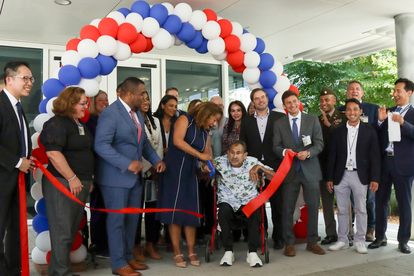 Attendants at the July 24 Tibor Rubin VA Medical Center Community Living Center ribbon-cutting ceremony cut the ceremonial ribbon in front of the building at Long Beach, California.