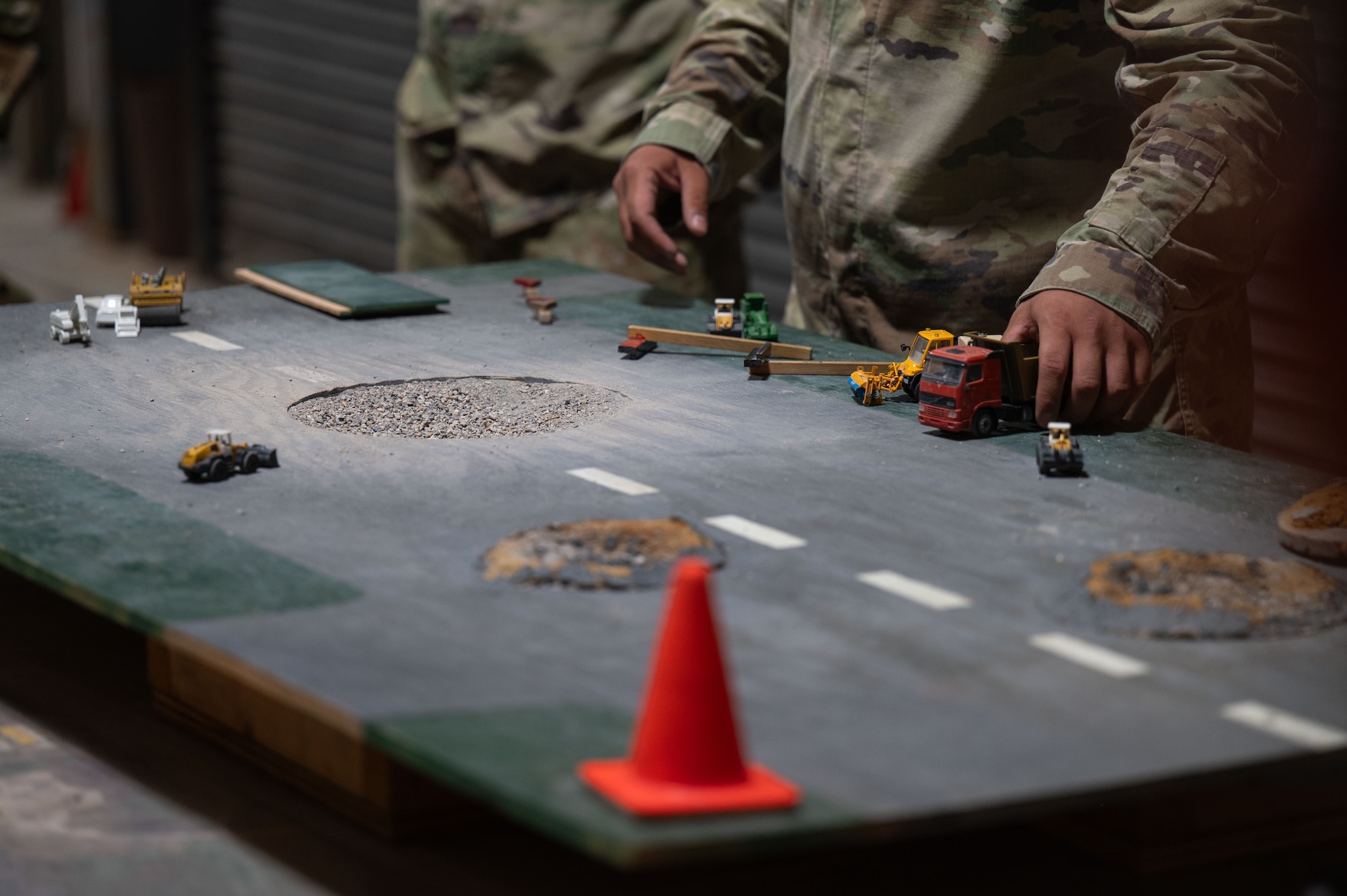 U.S. Air Force Airmen assigned to the 355th Combat Air Base Squadron learn about flightline repair during Exercise Coyote Storm 26.1 at Tyndall Air Force Base, Florida, July 20, 2026. CS 26.1 gave Airmen hands-on experience in expeditionary operations, from base construction to emergency response. (U.S. Air Force photo by Airman 1st Class Jaden Kidd)
