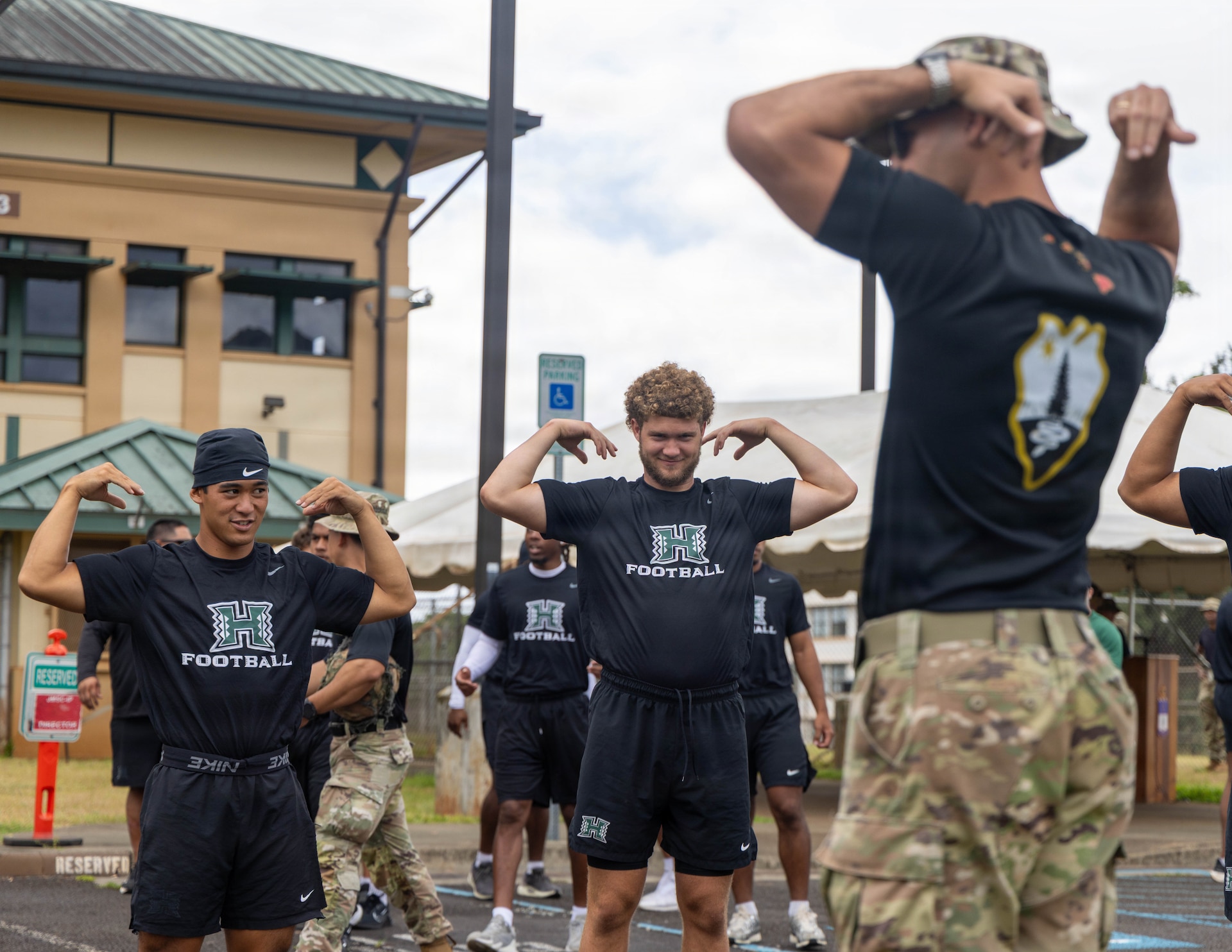 A U.S. Army Noncommissioned Officer with 2nd Battalion, 21st Infantry Regiment, 3rd Mobile Brigade, 25th Infantry Division, leads University of Hawaii Rainbow Warrior football players in warm up drills after the opening ceremony for a team-building day at the 1st Lt. Nainoa Hoe Mission Training Complex on Schofield Barracks, Hawaii, July 24, 2026.