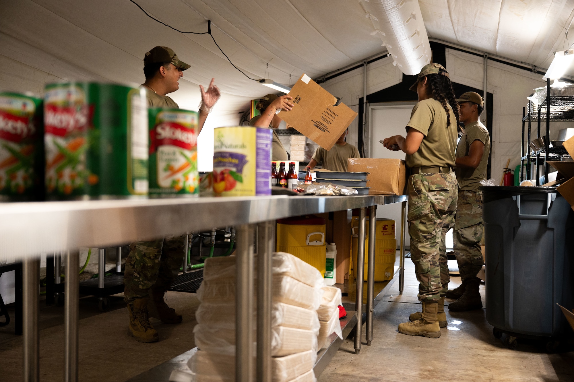 U.S. Air Force Airmen assigned to the 355th Force Support Squadron, prepare dinner during Exercise Coyote Storm 26.1 at Tyndall Air Force Base, Florida, July 22, 2026. CS 26.1 strengthened unit cohesion by integrating Airmen from multiple units into cross-functional teams prepared to meet mission requirements. (U.S. Air Force photo by Airman 1st Class Jaden Kidd)
