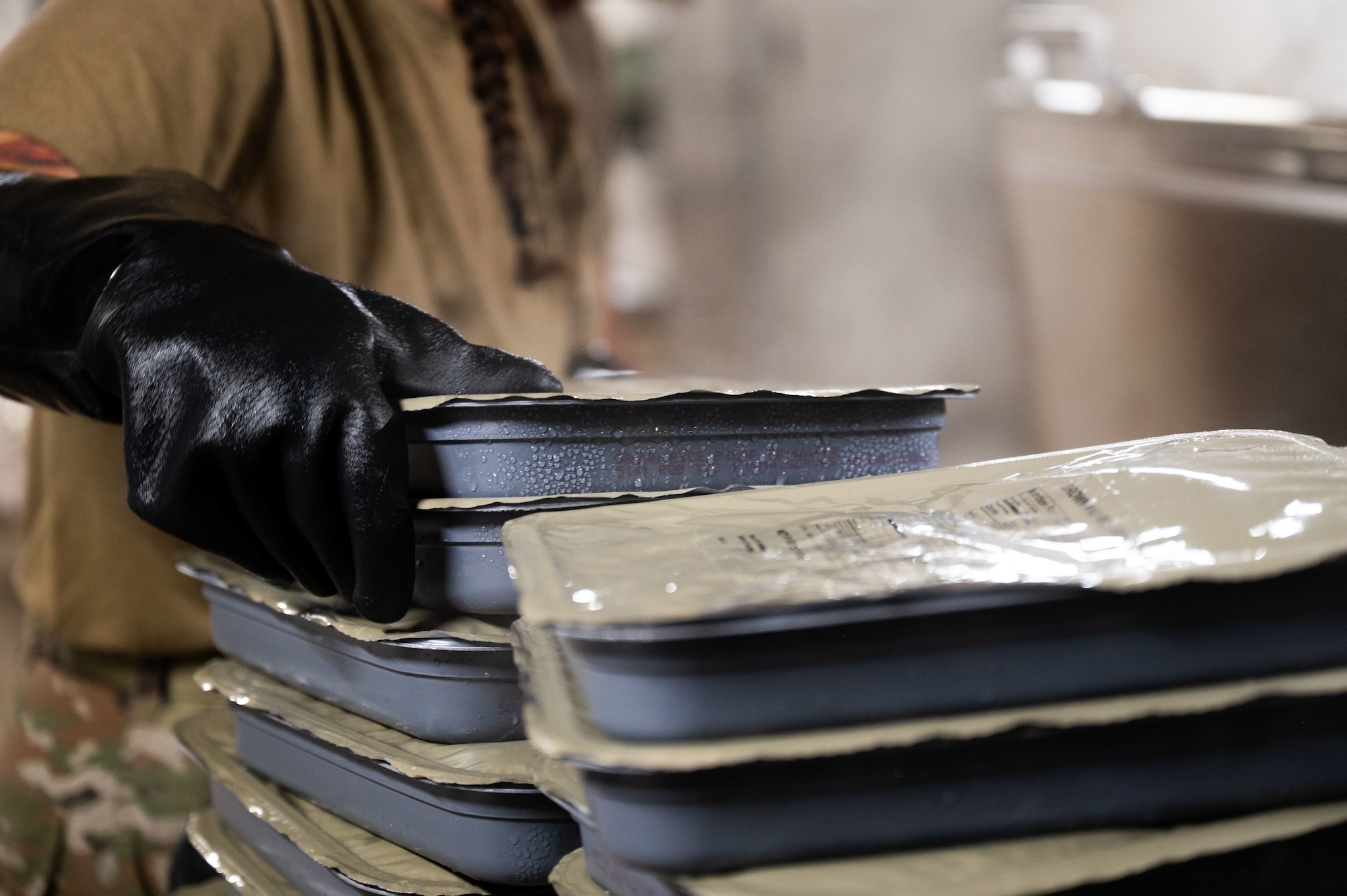 A U.S. Air Force Airman assigned to the 355th Force Support Squadron, prepares dinner during Exercise Coyote Storm 26.1 at Tyndall Air Force Base, Florida, July 22, 2026. During the exercise, Airmen built on previous experience by working in cross-functional teams organized according to specialty and mission requirements. (U.S. Air Force photo by Airman 1st Class Jaden Kidd)
