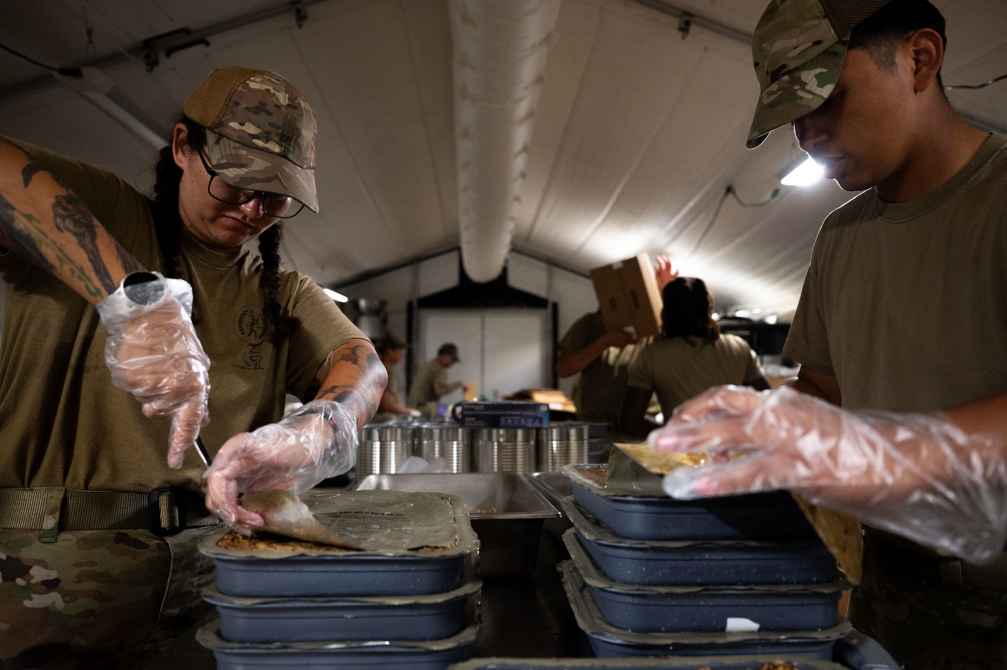 U.S. Air Force Airmen assigned to the 355th Force Support Squadron, prepare dinner during Exercise Coyote Storm 26.1 at Tyndall Air Force Base, Florida, July 22, 2026. Airmen were equipped with the skills needed to maintain strategic deterrence in austere and unpredictable environments. (U.S. Air Force photo by Airman 1st Class Jaden Kidd)