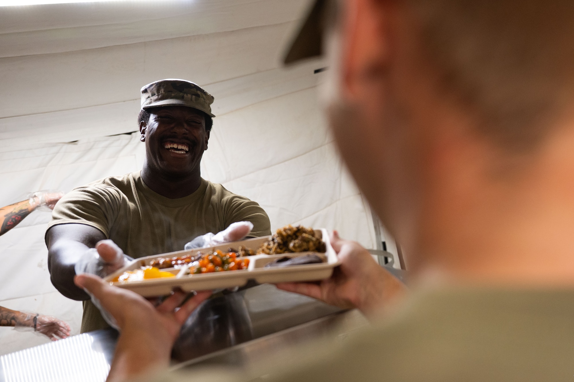A U.S. Air Force Airman assigned to the 355th Force Support Squadron, serves food during Exercise Coyote Storm 26.1 at Tyndall Air Force Base, Florida, July 22, 2026. The exercise provided Airmen hands-on experience responding to high-intensity scenarios in deployed environments. (U.S. Air Force photo by Airman 1st Class Jaden Kidd)