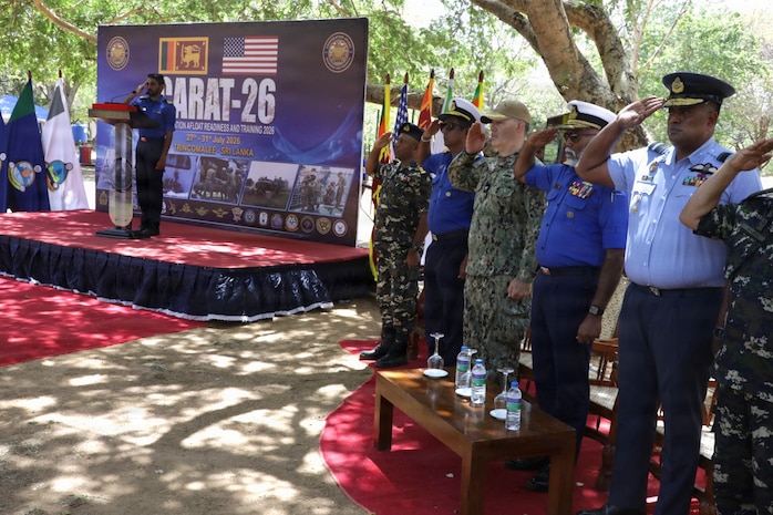 Sri Lanka Navy Rear Adm. Buddhika Liyanagamage, Eastern Naval Area Commander, second from right, and U.S. Navy Capt. Michael Messenger, deputy commander, Expeditionary Strike Group 7, third from right, salute during the Sri Lankan and American national anthems at the Cooperation Afloat Readiness and Training (CARAT) Sri Lanka 2026 opening ceremony in Trincomalee, Sri Lanka, July 27, 2026.