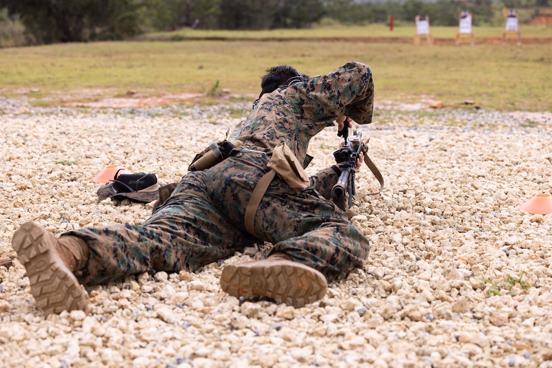 U.S. Marine Corps Staff Sgt. Christian Cochola, a Communication and Strategy Operations Chief with Marine Corps Installations Pacific, adjusts a rifle combat optic during a Communication Strategy and Operations field training exercise on Camp Hansen, Okinawa, Japan, April 7, 2026. The COMMSTRAT FTX is a five-day event focused on increasing quick decision-making skills and tactical proficiency through high pressure environments to provide commanders with more capable COMMSTRAT forces. (U.S. Marine Corps photo by Cpl. Ella Cadby)