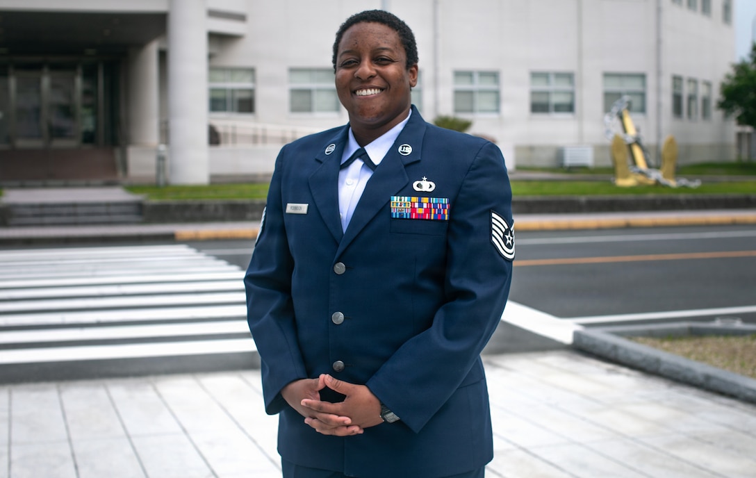 U.S. Air Force Tech. Sgt. Janiqua Robinson, a public affairs craftsman with Stars and Stripes, War Media Activity, Marine Corps Air Station Iwakuni, and a native of Clinton, Maryland, poses for a photo at Marine Corps Air Station Iwakuni, Japan, May 8, 2026. Robinson researches and produces multimedia products that incorporate various major commands throughout the Indo-Pacific to help communicate messages to both the public and Department of War leadership. (U.S. Marine Corps photo by Lance Cpl. Kenneth Garcia)