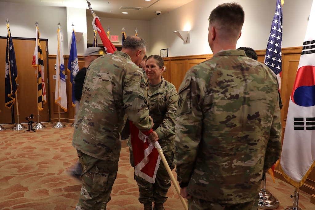Brig. Gen. Joseph C. “Clete” Goetz II, U.S. Army Corps of Engineers (USACE) – Pacific Ocean Division (POD) commanding general, passes the district colors to Col. Margaret “Maggie” Maasberg, the incoming commander of the USACE Far East District (FED), during a change of command ceremony held at River Bend Golf Course, USAG Humphreys, Republic of Korea, July 27, 2026. Maasberg, who most recently served as the chief of staff of the U.S. Army Engineer School at Fort Leonard Wood, Missouri, brings more than two decades of engineering and leadership experience to her new role as the 40th Commander of FED. (U.S. Army Photo by Yohan An)