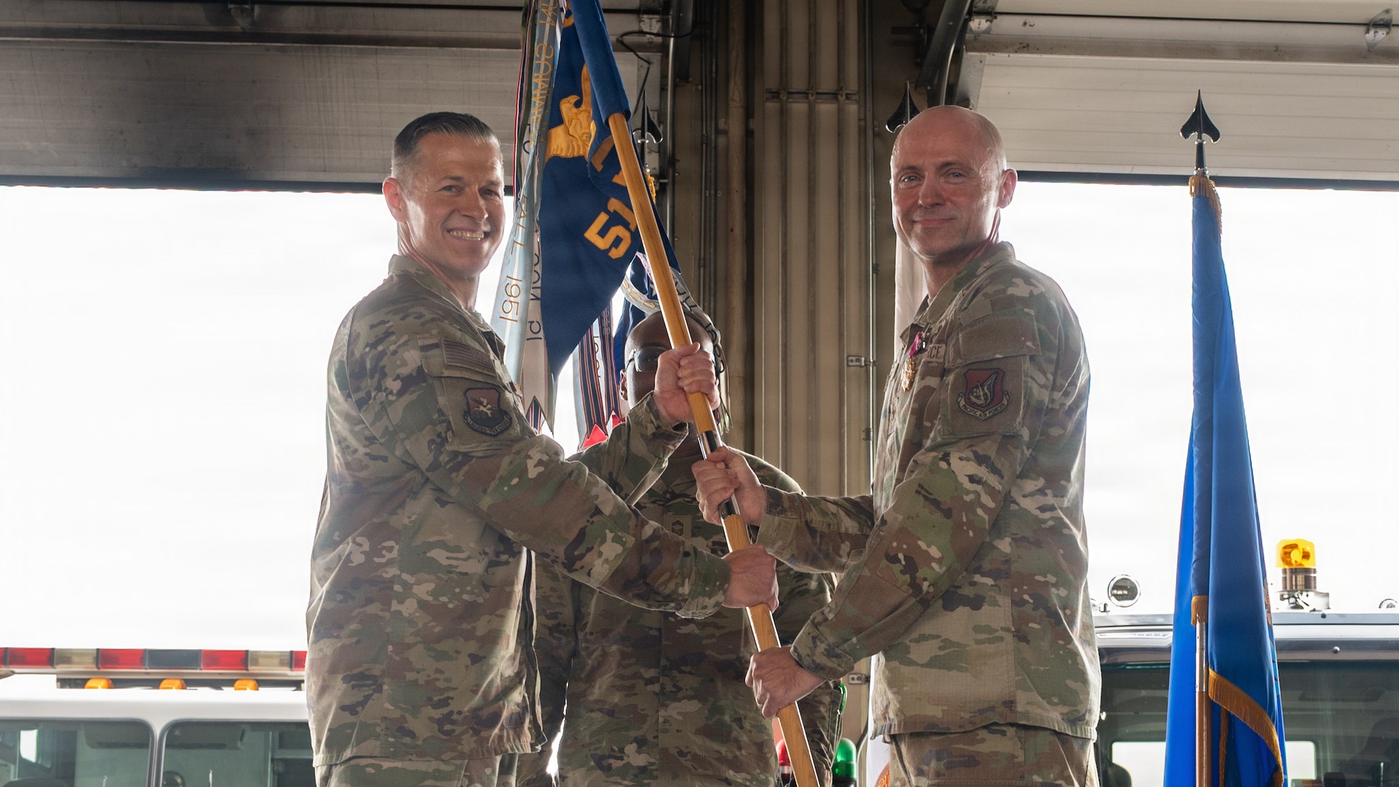 People pose with a guidon.