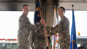 People pose with a guidon.