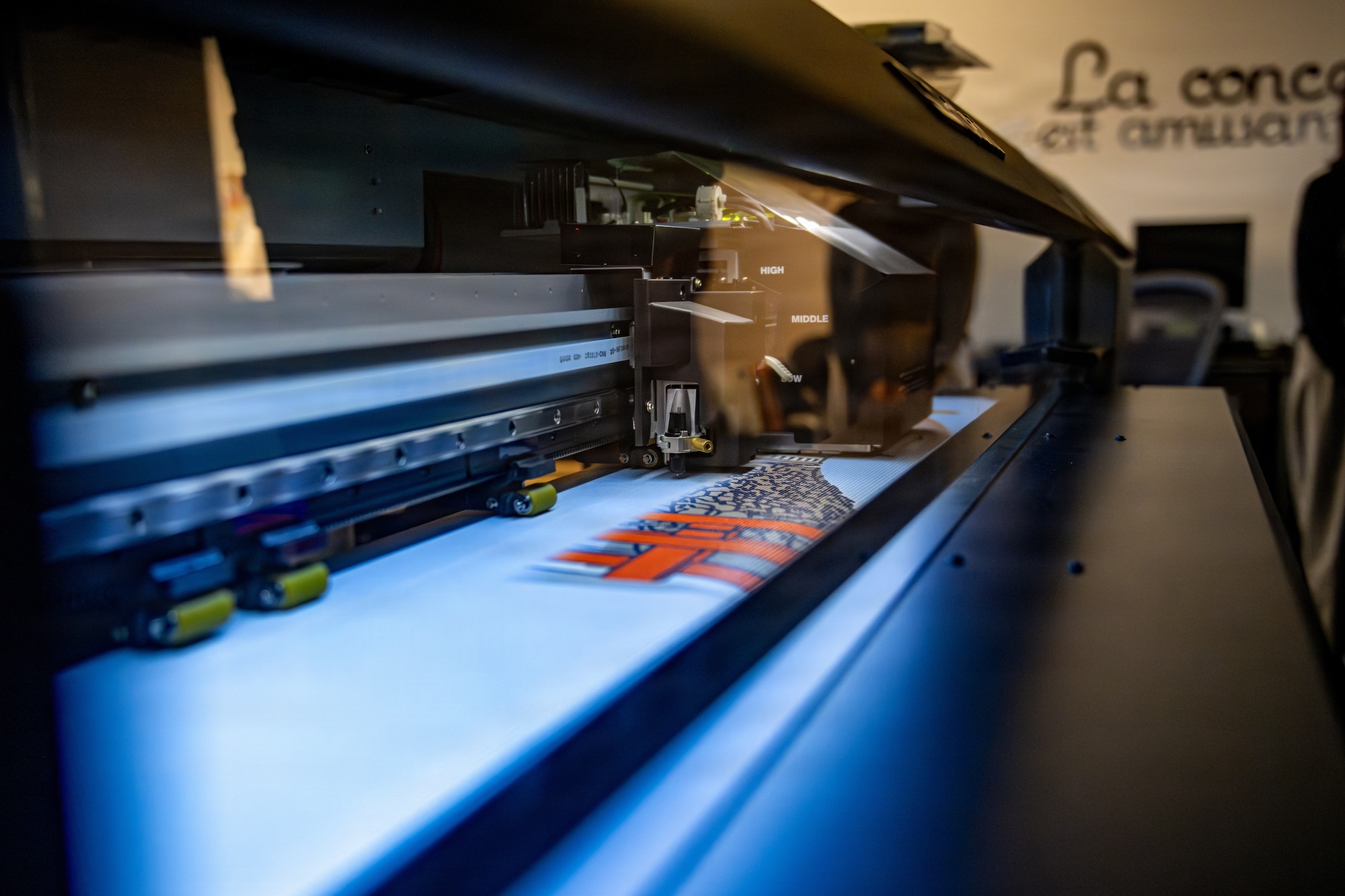 A large-format poster printer displays its printing capabilities during a Wild Weasel Walk-Through.