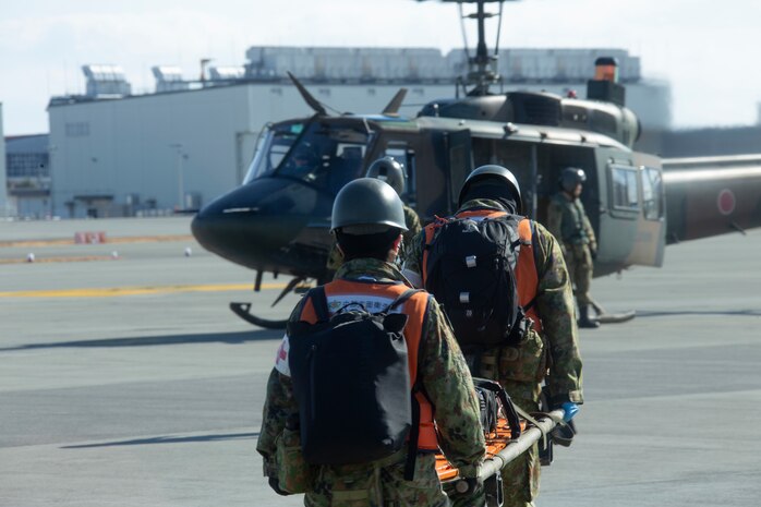 Japan Ground Self-Defense Force members with 13th Brigade, Middle Army, carry a stretcher to a JGSDF UH-1Y helicopter during Exercise Nankai Rescue at Marine Corps Air Station Iwakuni, Japan, Jan. 16, 2025.