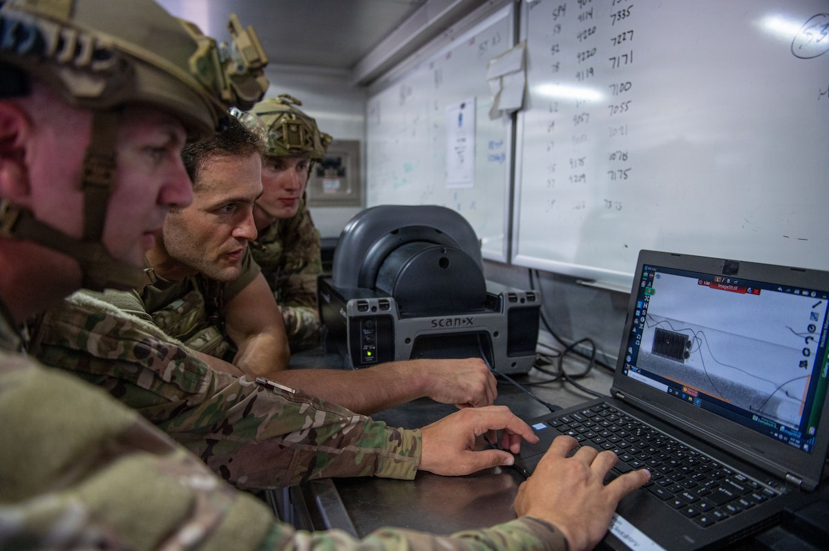 U.S. Air Force explosive ordnance disposal technicians inspect an X-ray during a simulated hazard component separation during the fourteenth annual Audacious Warrior exercise, at Volk Field Air National Guard Base, Camp Douglas, Wisconsin, July 20, 2026. Audacious Warrior is an annual exercise designed to convene explosive ordnance disposal technicians from various backgrounds to train on the latest EOD scenarios, enhance operational readiness, and exchange knowledge and techniques. (U.S. Air National Guard photo by Senior Airman Jessica Duch)