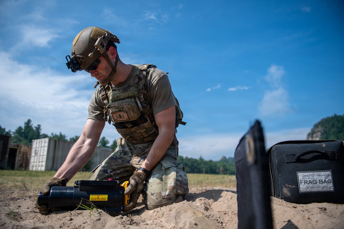 A U.S. Air Force explosive ordnance disposal technician conducts a simulated hazard component separation during the fourteenth annual Audacious Warrior exercise, at Volk Field Air National Guard Base, Camp Douglas, Wisconsin, July 20, 2026. Audacious Warrior is an annual exercise designed to convene explosive ordnance disposal technicians from various backgrounds to train on the latest EOD scenarios, enhance operational readiness, and exchange knowledge and techniques. (U.S. Air National Guard photo by Senior Airman Jessica Duch)