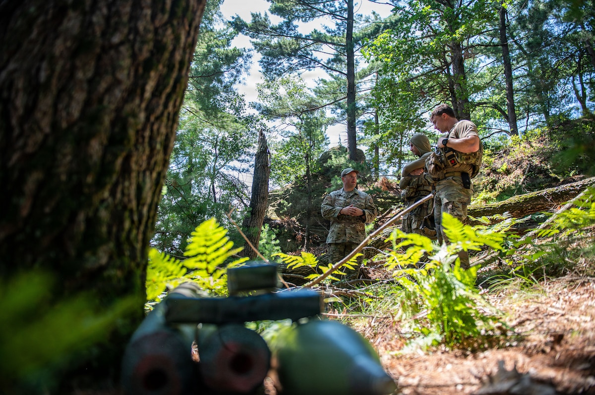 U.S. Airmen assigned to the 155th Air Refueling Wing, Nebraska Air National Guard, Lincoln, Nebraska and the 325th Civil Engineer Squadron, Tyndall Air Force Base, Florida, discuss a simulated point of origin investigation during the fourteenth annual Audacious Warrior exercise, at Volk Field Air National Guard Base, Camp Douglas, Wisconsin, July 20, 2026. Audacious Warrior is an annual exercise designed to convene explosive ordnance disposal technicians from various backgrounds to train on the latest EOD scenarios, enhance operational readiness, and exchange knowledge and techniques. (U.S. Air National Guard photo by Senior Airman Jessica Duch)