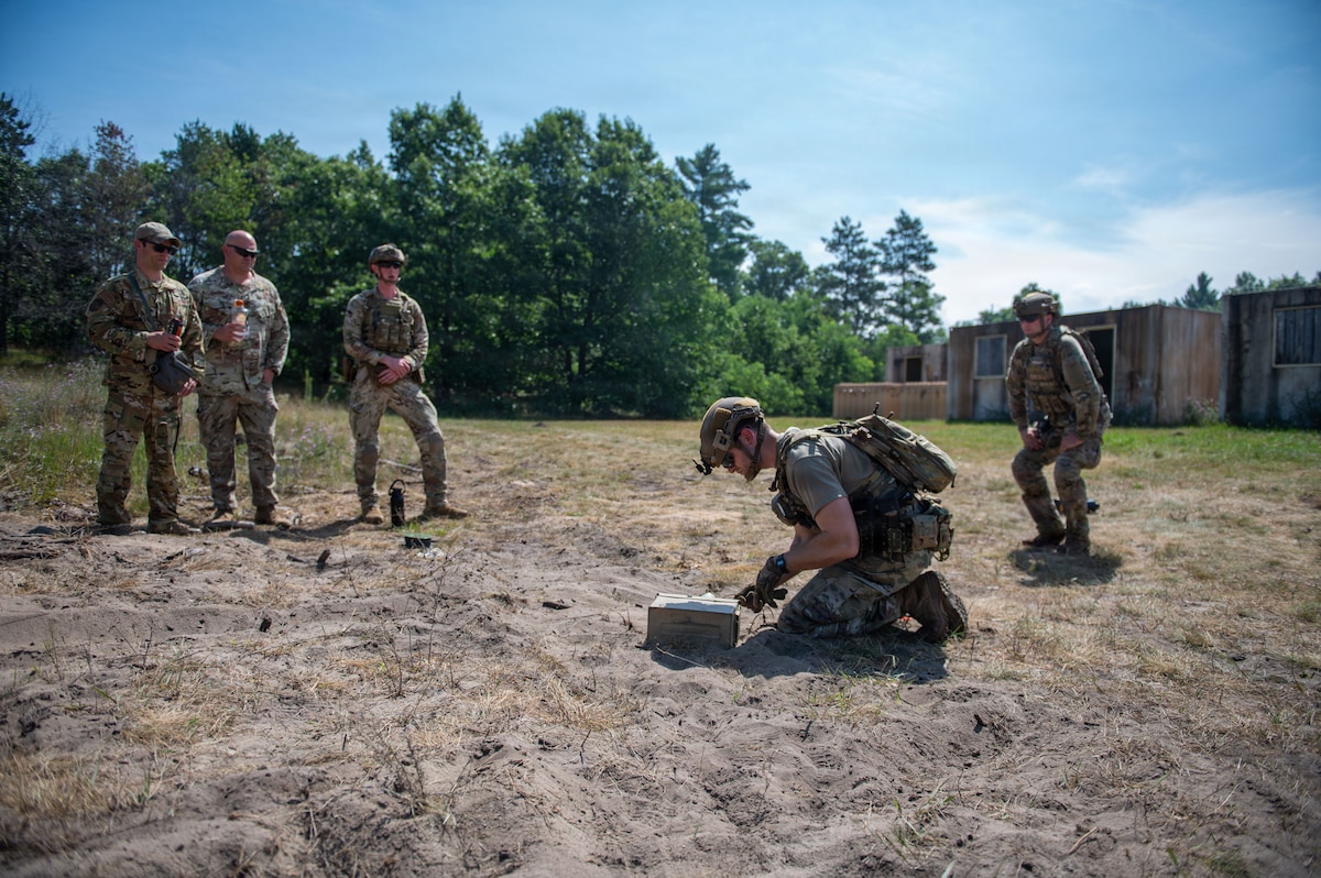 U.S. Air Force explosive ordnance disposal technicians observe a simulated hazard component separation during the fourteenth annual Audacious Warrior exercise, at Volk Field Air National Guard Base, Camp Douglas, Wisconsin, July 20, 2026. Audacious Warrior is an annual exercise designed to convene explosive ordnance disposal technicians from various backgrounds to train on the latest EOD scenarios, enhance operational readiness, and exchange knowledge and techniques. (U.S. Air National Guard photo by Senior Airman Jessica Duch)