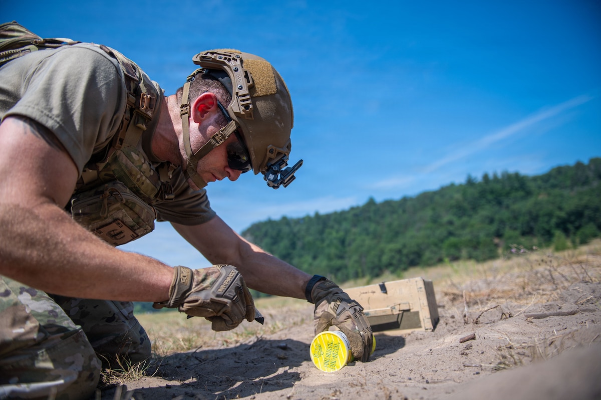 A U.S. Air Force explosive ordnance disposal technician conducts a simulated hazard component separation during the fourteenth annual Audacious Warrior exercise, at Volk Field Air National Guard Base, Camp Douglas, Wisconsin, July 20, 2026. Audacious Warrior is an annual exercise designed to convene explosive ordnance disposal technicians from various backgrounds to train on the latest EOD scenarios, enhance operational readiness, and exchange knowledge and techniques. (U.S. Air National Guard photo by Senior Airman Jessica Duch)