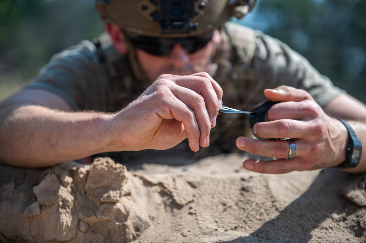 A U.S. Air Force explosive ordnance disposal technician conducts a simulated hazard component separation during the fourteenth annual Audacious Warrior exercise, at Volk Field Air National Guard Base, Camp Douglas, Wisconsin, July 20, 2026. Audacious Warrior is an annual exercise designed to convene explosive ordnance disposal technicians from various backgrounds to train on the latest EOD scenarios, enhance operational readiness, and exchange knowledge and techniques. (U.S. Air National Guard photo by Senior Airman Jessica Duch)