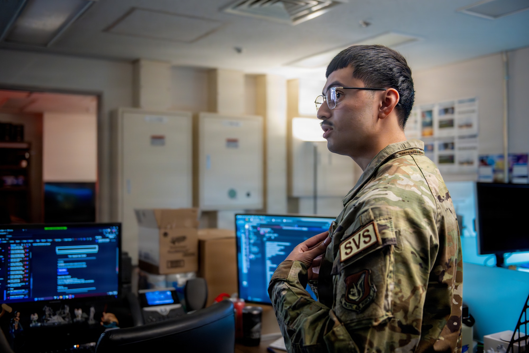 U.S. Air Force Senior Airman Edwin Jiminez Reyes, 35th Force Support Squadron marketing and publicity communications specialist, explains the ongoing projects of the marketing office during a Wild Weasel Walk-Through.