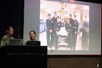 SAN DIEGO (May 14, 2026) — Lt. Cmdr. Kristine Tolentino Parra, right, and Lt. Stephanie Ryan, left, explain how the Expeditionary Medicine teams supported the historic Artemis II space recovery operations in April. Parra, a general surgeon and platform lead for Expeditionary Resuscitative Surgical System 14 at Navy Medicine Readiness and Training Command Camp Pendleton, and Ryan, a Navy nurse with En Route Care System 11 at NMRTC San Diego, shared their operational insights at the Naval Medical Forces Pacific headquarters. (U.S. Navy photo by Arsenio R. Cortez Jr.)