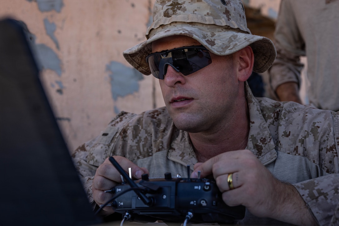 U.S. Marine Corps 1st Lt. Jack Bish, a Pennsylvania native and the officer in charge for the Unmanned Systems Center of Excellence, 2nd Marine Division, flies a Bumblebee V1 drone using a controller on Range 210 during Service Level Training Exercise 4-26 on Marine Corps Air Ground Combat Center, Twentynine Palms, California, July 25, 2026. SLTE 4-26 is designed to be a challenging, realistic training environment that produces combat-ready forces capable of operating as an integrated Marine Air Ground Task Force across all domains of military operations. (U.S. Marine Corps photo by Sgt. Alexis French)