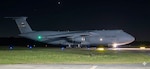 Side view of a C-5 Super Galaxy on tarmac at night