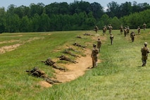U.S. Marines with Company C, The Basic School, Training Command, suppress a machine gun bunker at Marine Corps Base Quantico, Virginia, July 1, 2026. The training evaluated students' ability to maneuver, communicate, and employ supporting fires while assaulting a fortified enemy position. (U.S. Marine Corps photo by Cpl. Memphis Pitts)