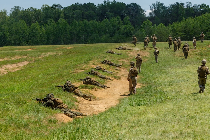 U.S. Marines with Company C, The Basic School, Training Command, suppress a machine gun bunker at Marine Corps Base Quantico, Virginia, July 1, 2026. The training evaluated students' ability to maneuver, communicate, and employ supporting fires while assaulting a fortified enemy position. (U.S. Marine Corps photo by Cpl. Memphis Pitts)