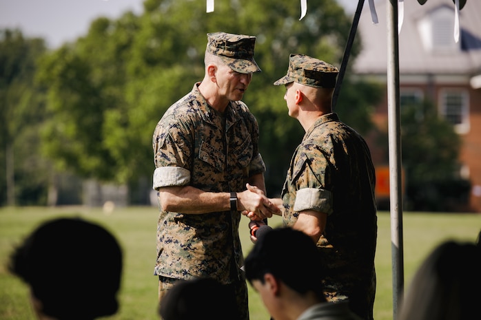 U.S. Marine Corps Col. Robert G. McCarthy III, the outgoing commanding officer of The Basic School, left, shakes hands with Col. Charles E. Miller II, the incoming commanding officer of TBS during a change of command ceremony at Marine Corps Base Quantico, Virginia, July 15, 2026. During the ceremony, McCarthy relinquished command of TBS to Miller. (U.S. Marine Corps photo by Cpl. Joshua Barker)