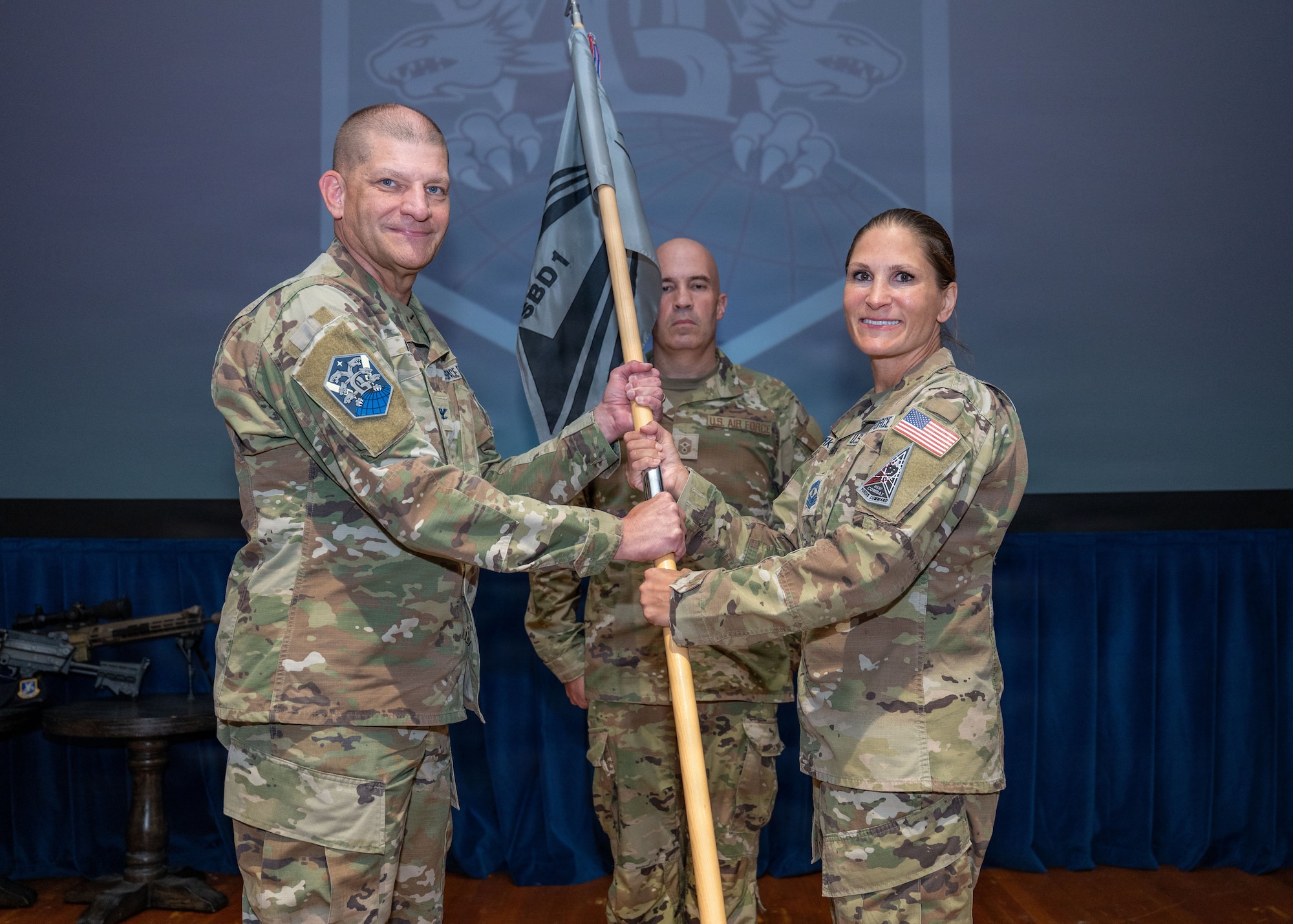 Chief Master Sgt. Martha Burkhead surrenders the guidon to Col. Kenneth Klock.