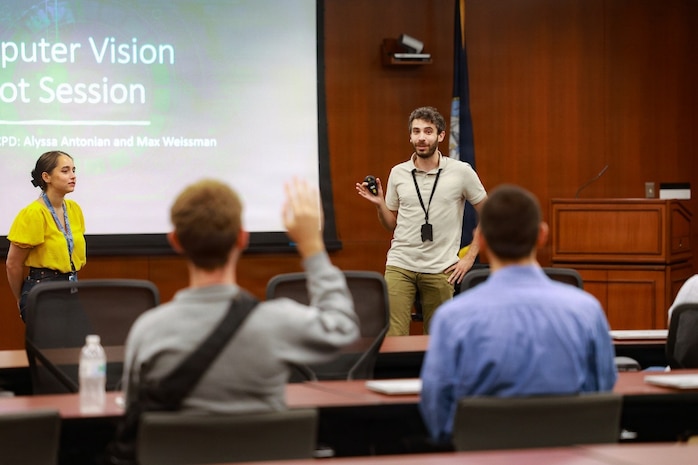 Naval Surface Warfare Center, Philadelphia Division Advanced Data Acquisition, Prototyping Technologies, and Virtual Environments (ADAPT.VE) Laboratory software engineer Alyssa Antonian and robotic engineer Max Weissman lead an inaugural hands-on computer vision workshop for 16 college students from around the Nation on July 15, 2026. (U.S. Navy photo by Jay Butterbaugh, CTR)