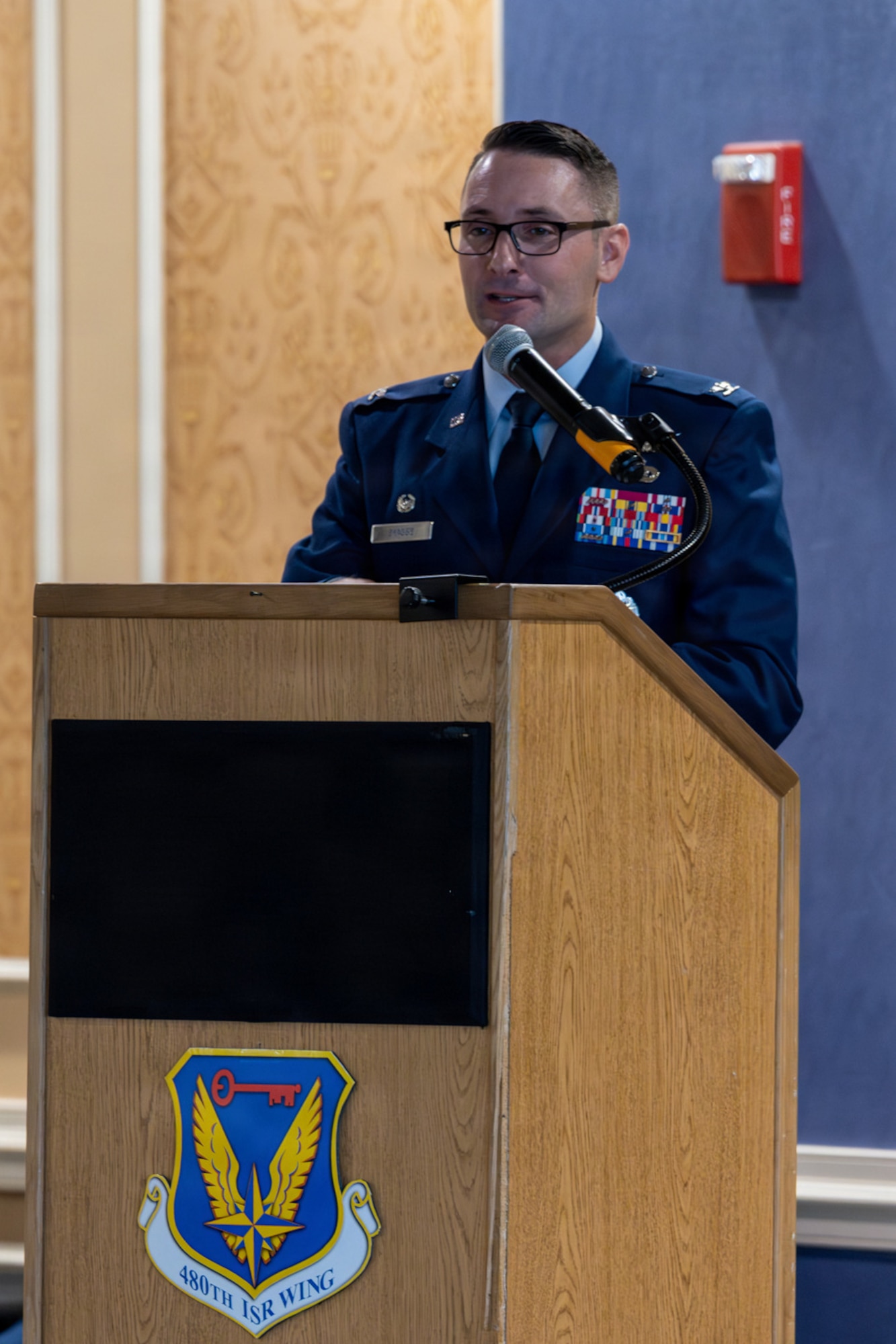 An Airman stands at a podium.
