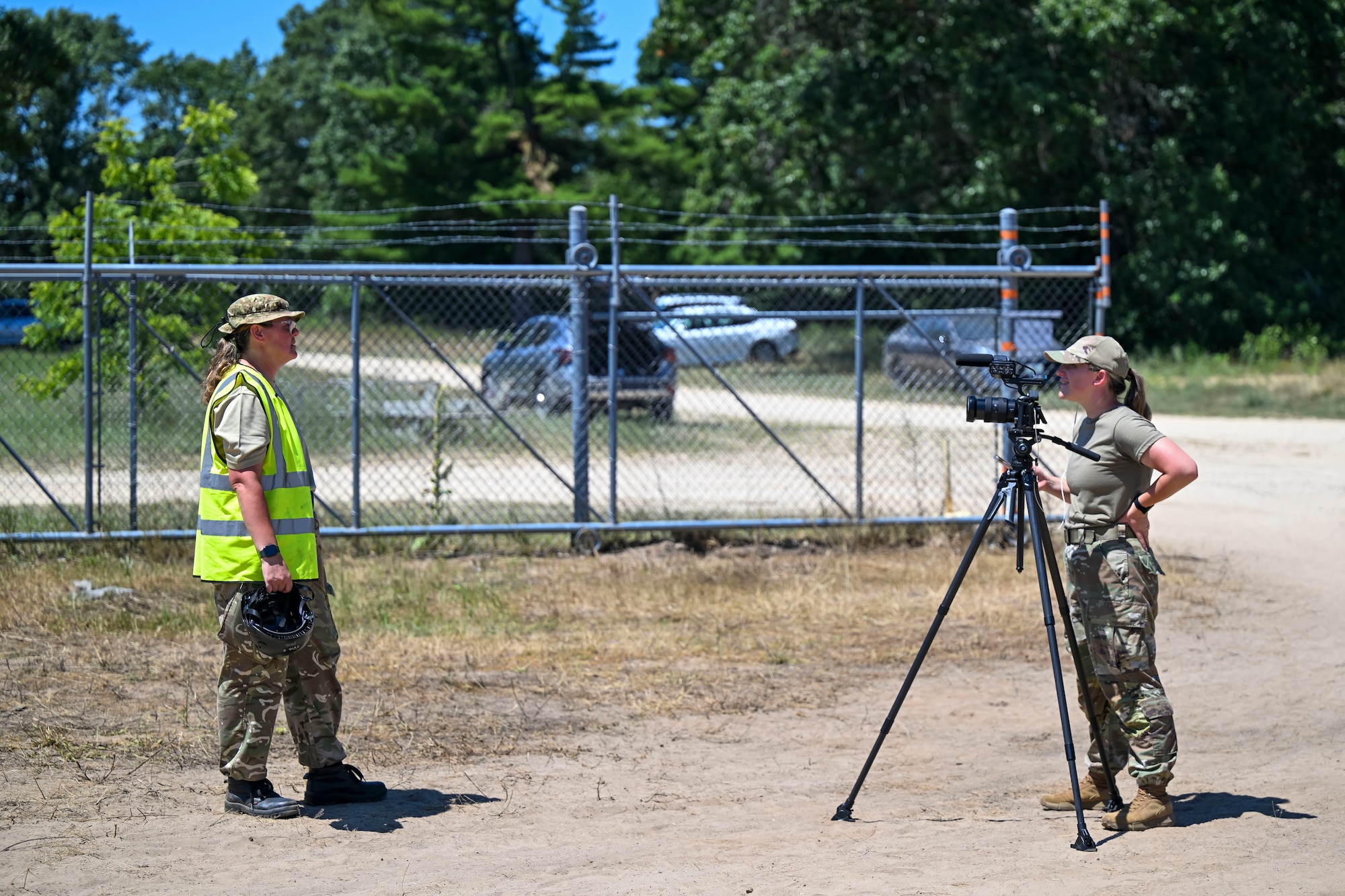 U.S. Air Force Tech. Sgt. Darby Arnold, public affairs specialist, I.G. Brown Training and Education Center University, films Petty Officer Tina Keel, Royal Navy, United Kingdom, as she participates in an interview during the F-35 Joint Program Office Advanced Crash Damaged or Disabled Aircraft Recovery (CDDAR) course at Volk Field Combat Readiness Training Center, Wisconsin, July 14, 2026. The advanced CDDAR course challenged participants to solve complex recovery scenarios while improving joint integration, critical thinking and multinational interoperability. (U.S. Air National Guard photo by Master Sgt. Regina Young)