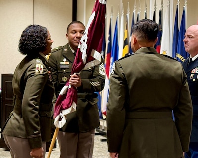Sgt. Maj. Devon Woodard accepts the unit’s colors from Munson Army Health Center Director and U.S. Army MEDDAC Fort Leavenworth, Commander Col. Jolanda L.J. Walker during a change of responsibility ceremony on post July 24, 2026. Woodard assumed Senior Enlisted Advisor responsibilities from Sgt. Maj. Jason L. Trevino.
