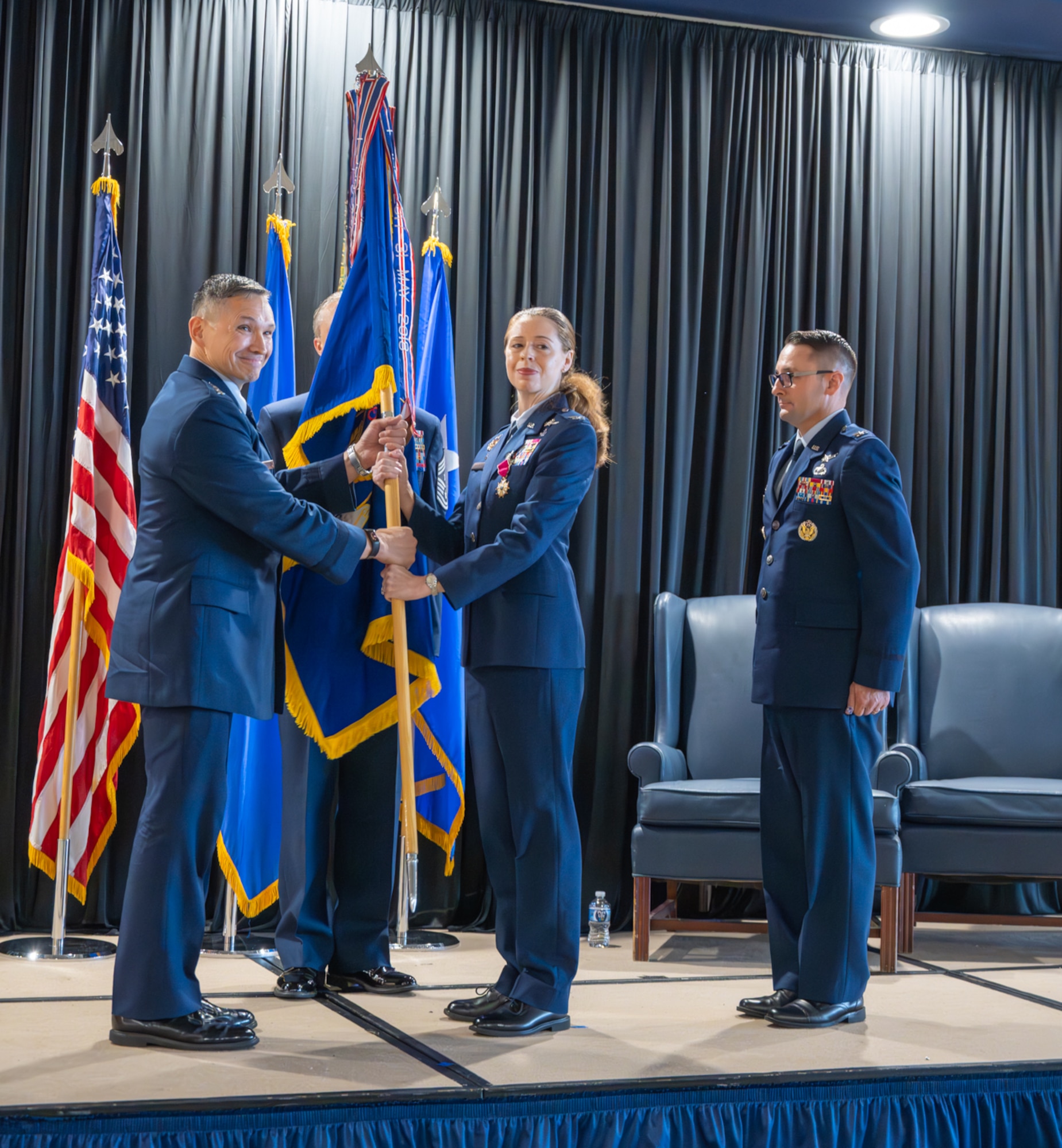 Two Airmen hold a guidon.