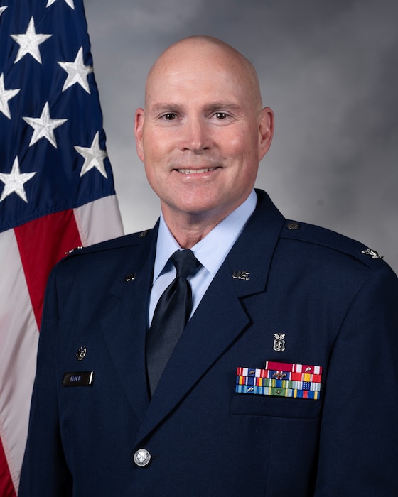 A person posing for an official photo in a military uniform.