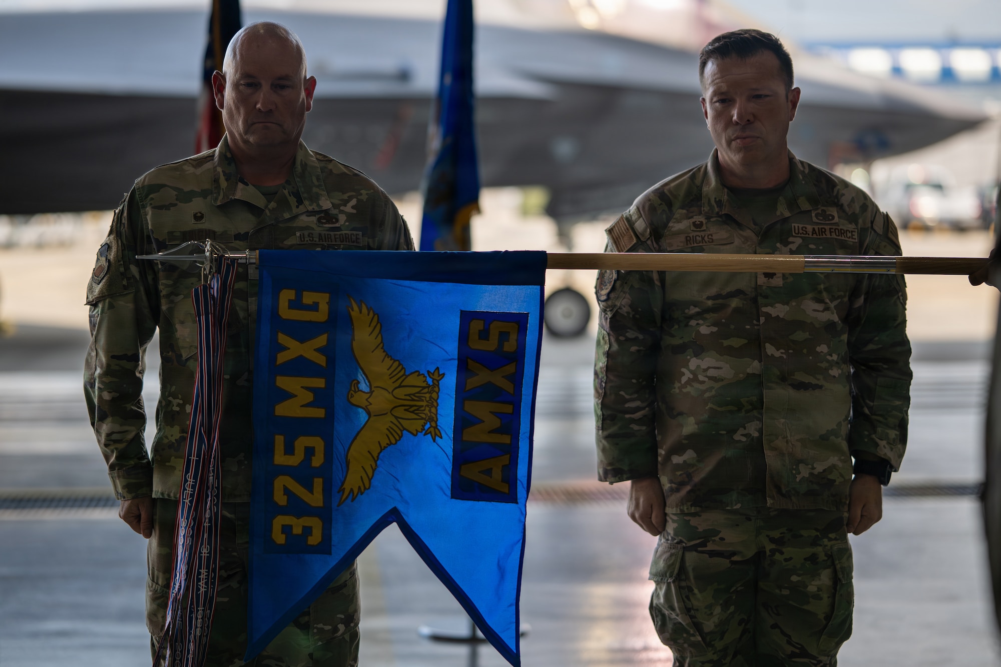 The guidon for the newly reactivated 325th Aircraft Maintenance Squadron is unfurled during a ceremony at Tyndall Air Force Base, Florida, July 27, 2026.