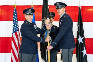 U.S. Space Force Col. Charles Cooper, incoming Space Base Delta 1 commander, accepts the guidon from Lt. Gen. Gregory Gagnon,