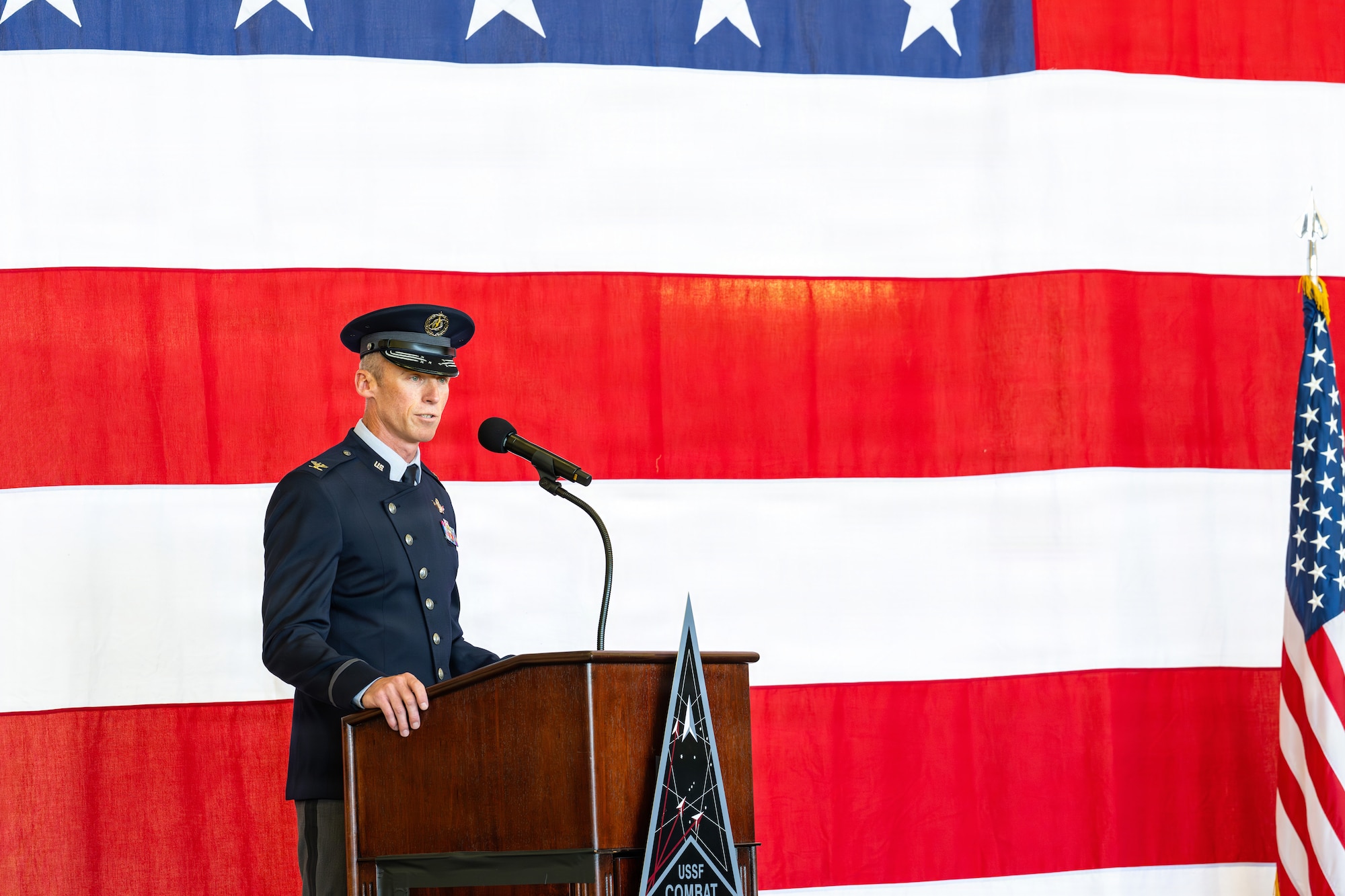 U.S. Space Force Col. Charles Cooper, incoming Space Base Delta 1 commander, gives remarks