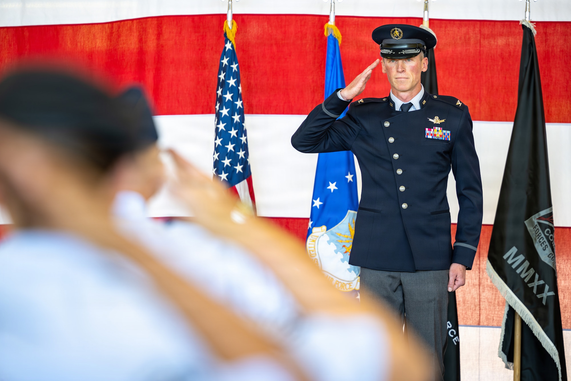 U.S. Space Force Col. Charles Cooper, incoming Space Base Delta 1 commander, renders his first salute to a formation of Guardians and Airmen