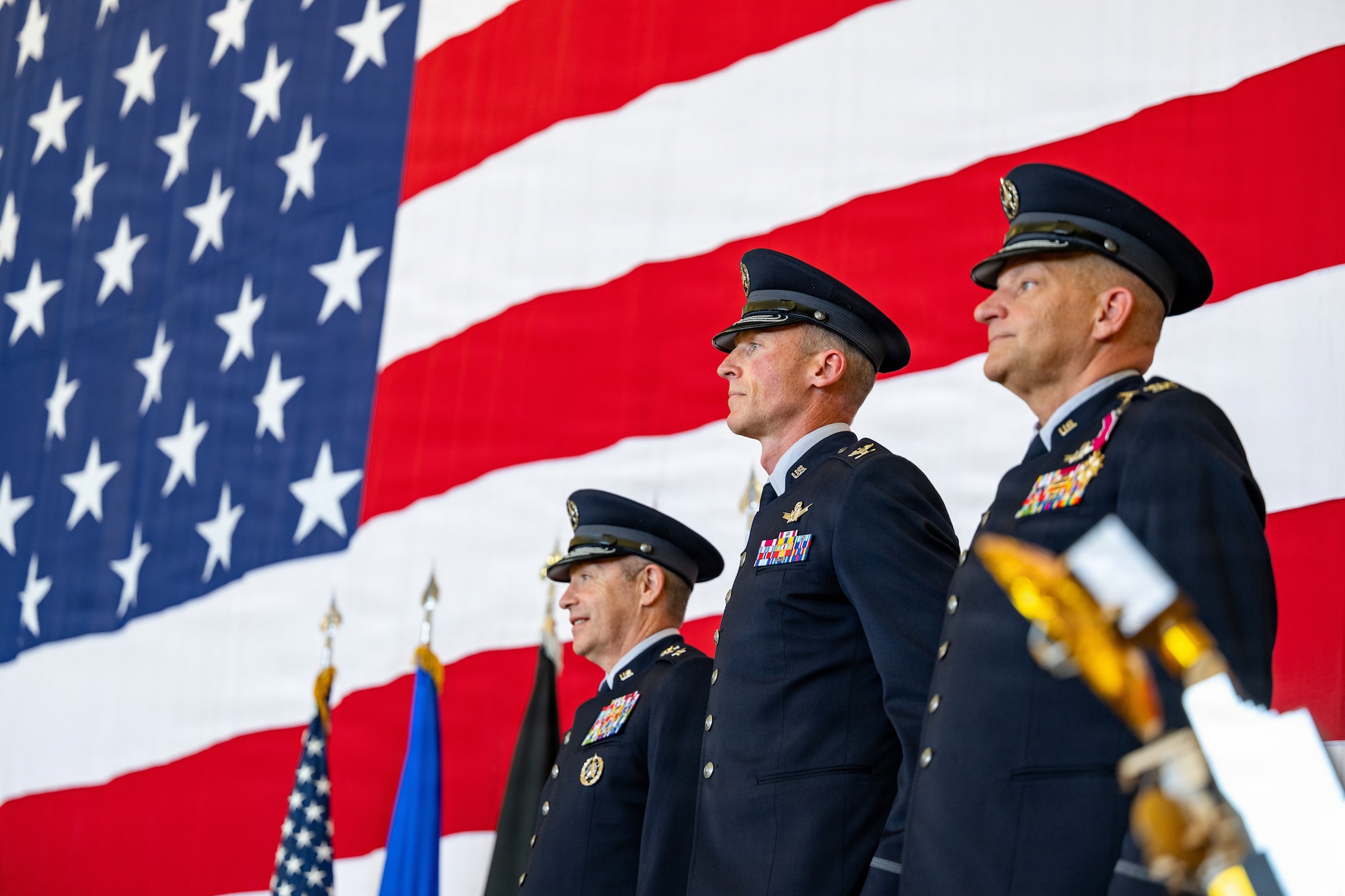 From the left, U.S. Space Force Lt. Gen. Gregory Gagnon, Combat Forces Command commander, Col. Charles Cooper, Space Base Delta 1 commander, and Col. Kenneth Klock, outgoing SBD 1 commander, stand at attention