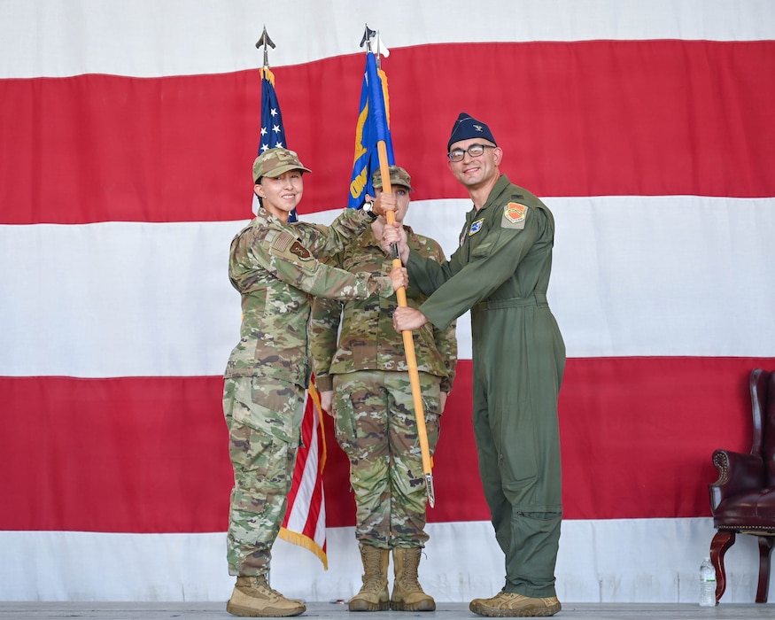 U.S. Air Force Col. Adrianne Rosario, Luke Medical Group commander, passes the guidon to Col. Bashir El-Khoury, incoming Luke Operational Medical Readiness Squadron commander, during an assumption of command ceremony at Luke Air Force Base, Arizona, July 27, 2026. The ceremony symbolized the establishment of authority as El-Khoury assumed command of the squadron, supporting the 56th Fighter Wing’s rapid modernization and advanced F-35A Lightning II training standards, projecting unmatched U.S. power worldwide. (U.S. Air Force photo by Airman 1st Class Rebecca Wagner)