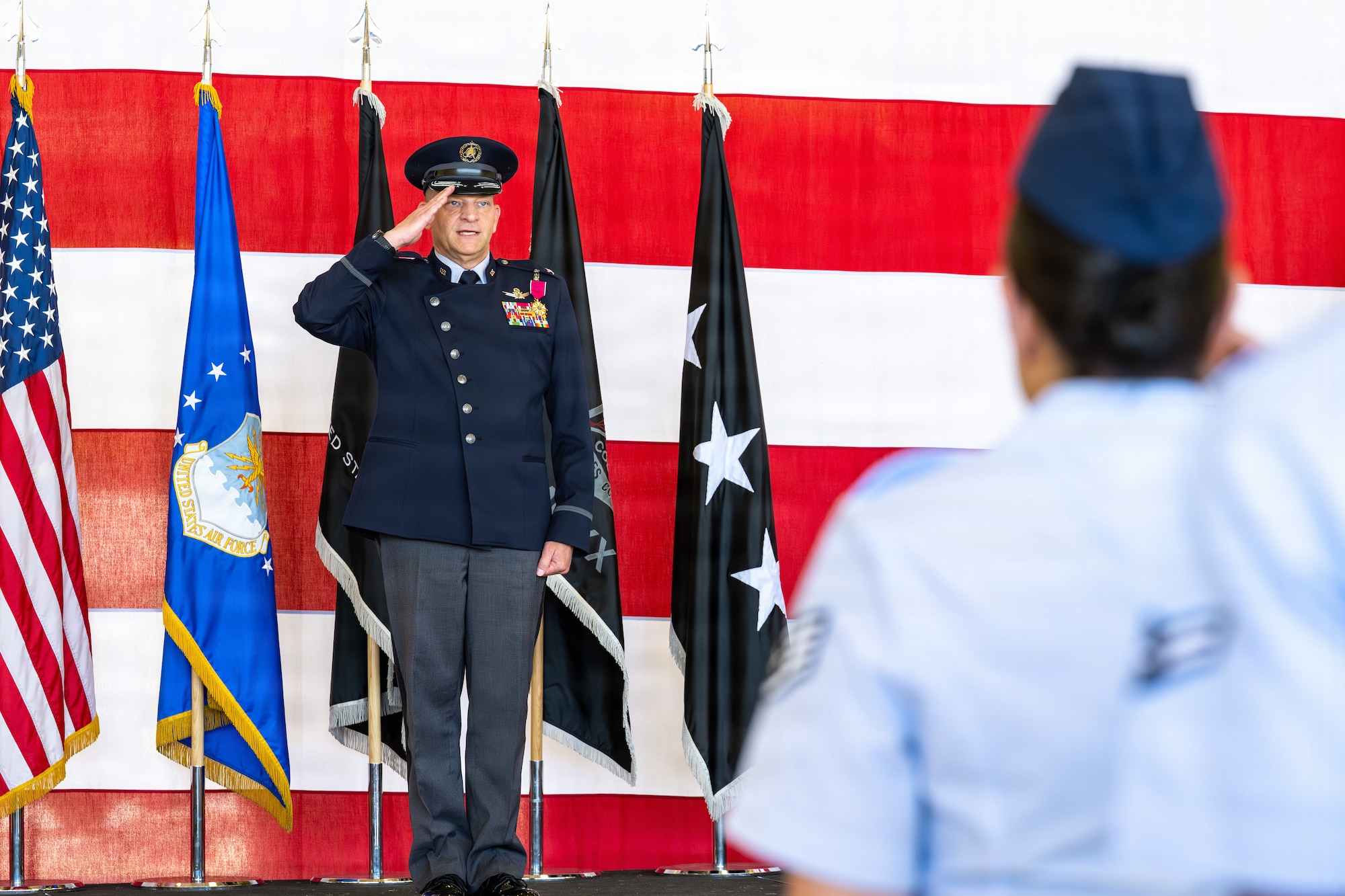 U.S. Space Force Col. Kenneth Klock, outgoing Space Base Delta 1 commander, renders his final salute to a formation  of Guardians and Airmen