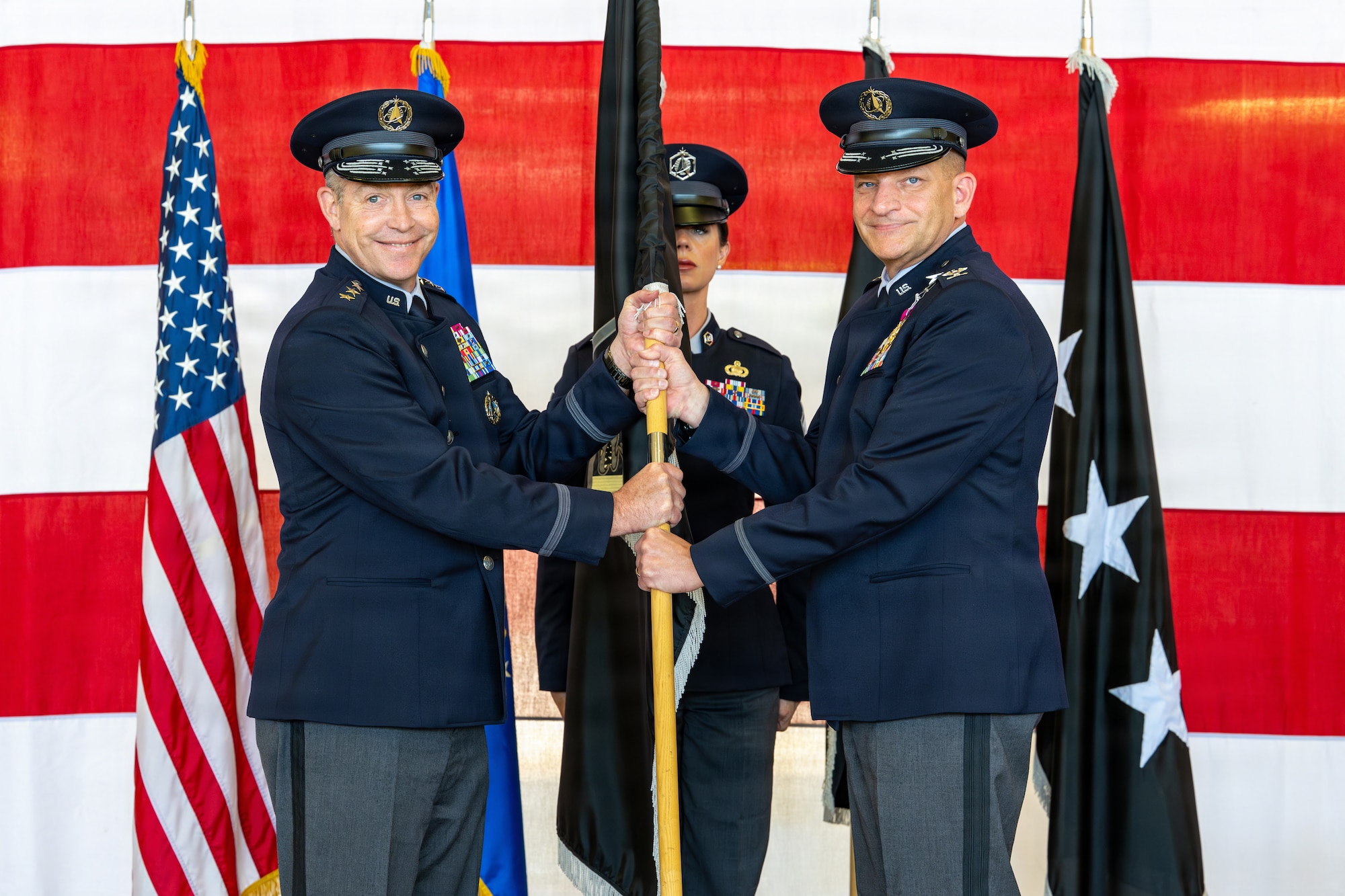 U.S. Space Force Col. Kenneth Klock, outgoing Space Base Delta 1 commander, surrenders the guidon to Lt. Gen. Gregory Gagnon