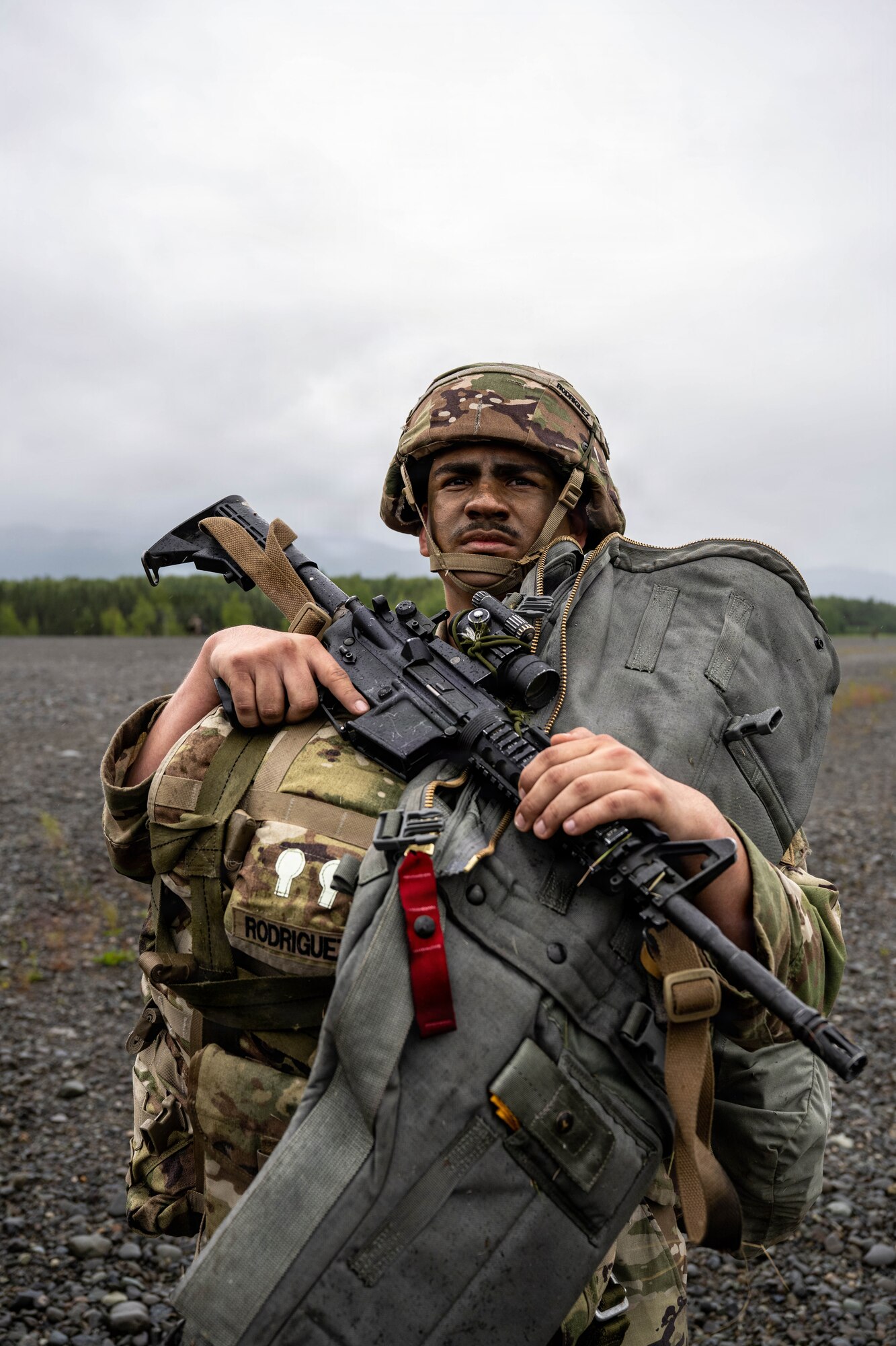 A U.S. Army paratrooper assigned to the 1st Battalion, 511th Parachute Infantry Regiment, 11th
Airborne Division, carries his equipment to an assigned assembly area following an airdrop
during Arctic Predictable Iron ’26 at Joint Base Elmendorf-Richardson, Alaska, July 15, 2026.
The exercise tested the unit’s ability to assemble and continue operations after an airborne
insertion. (U.S. Air Force photo by Senior Airman Lauren Torres)