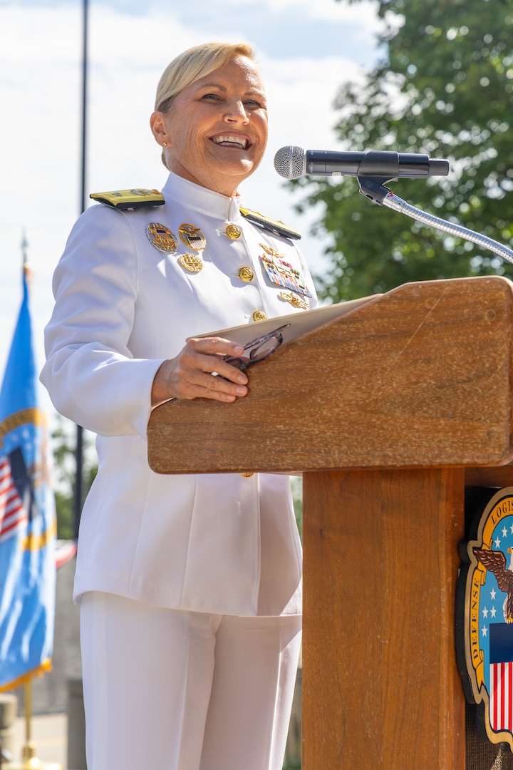 A woman in a Navy uniform speaks.
