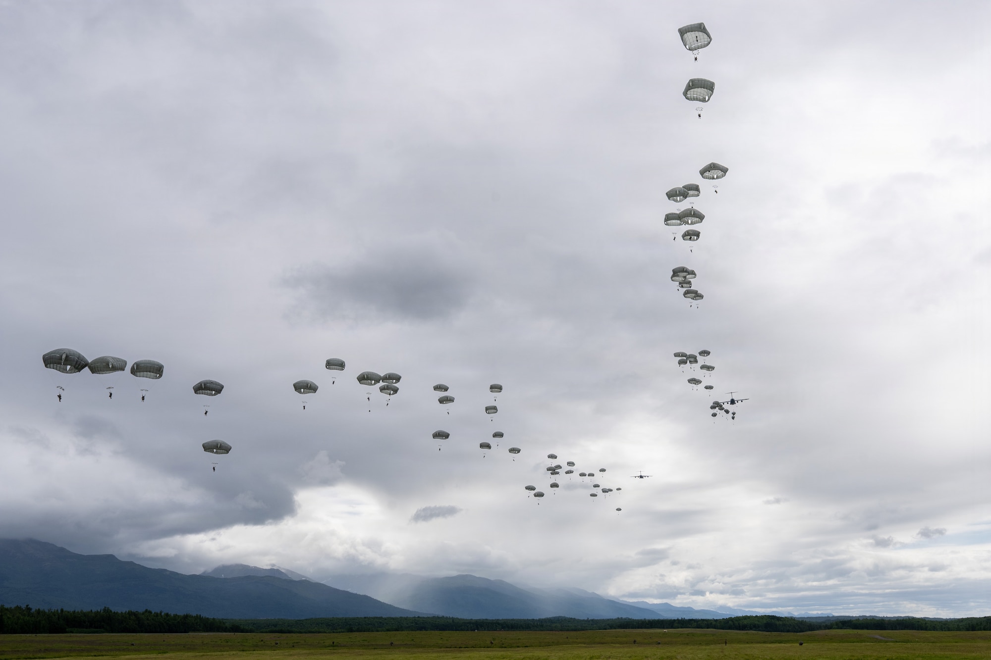 U.S. Paratroopers assigned to the 1st Battalion, 511th Parachute Infantry Regiment, 11th
Airborne Division, parachute from a C-17 Globemaster III during an airdrop as part of Arctic
Predictable Iron ’26 over Joint Base Elmendorf-Richardson, Alaska, July 15, 2026. The exercise
strengthened joint interoperability by integrating Air Force airlift capabilities with Army airborne
operations. (U.S. Air Force photo by Senior Airman Lauren Torres)