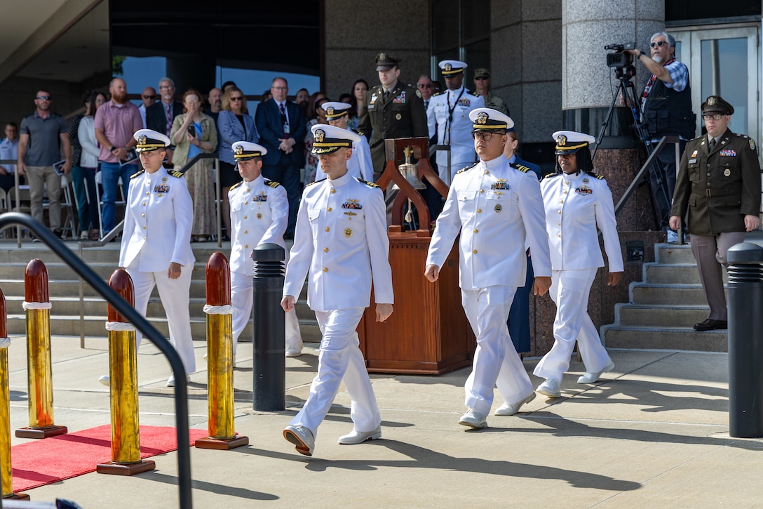 Several people in white Navy uniforms.