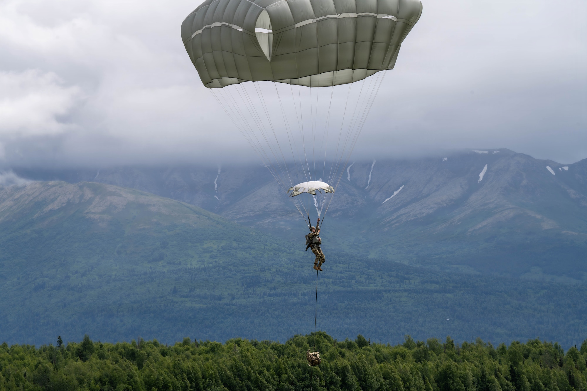 A U.S. Paratrooper assigned to the 1st Battalion, 511th Parachute Infantry Regiment, 11th
Airborne Division, prepares to land during an airdrop operation as part of Arctic Predictable Iron
’26 at Joint Base Elmendorf-Richardson, Alaska, July 15, 2026. The exercise enhanced
airborne readiness and strengthened coordination between Army paratroopers and Air Force
aircrews operating in Alaska’s challenging environment. (U.S. Air Force photo by Senior Airman
Lauren Torres)
